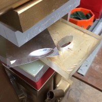 moving on to forming the pod form... I cut the elliptical form from extruded acrylic, shaped and beveled the edge to give a nice pressed form, and this is the first pressing of 22 gauge sheet sterling into the handmade die, in the hydraulic press. 6000 tons of pressure created one half of the form, in one pressing.