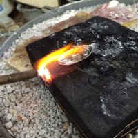 soldering the lilies to the backside of the pod