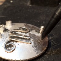 stippling the surface of the locket panel